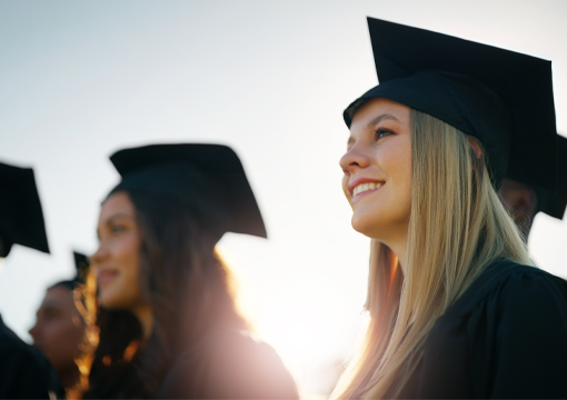 high school students wearing black graduation gowns and caps